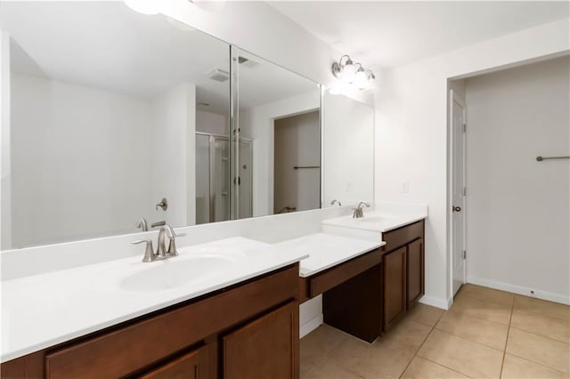 bathroom with a shower stall, tile patterned floors, vanity, and baseboards