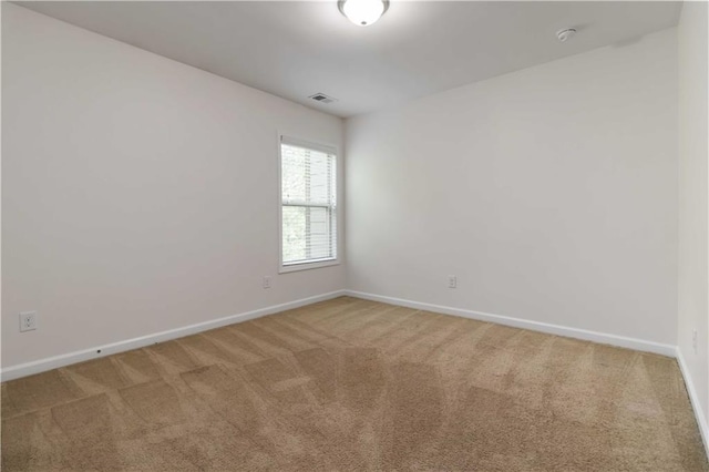 unfurnished room featuring carpet floors, baseboards, and a smoke detector