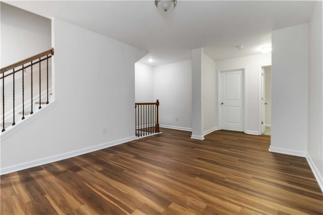empty room with wood finished floors and baseboards