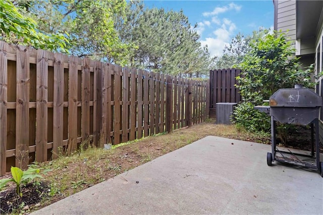 view of patio with a fenced backyard and central AC