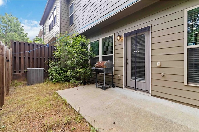 view of patio featuring central AC unit, fence, and grilling area