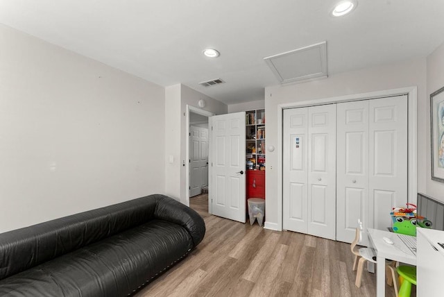 sitting room with attic access, light wood-style flooring, and recessed lighting