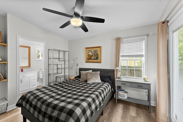 bedroom with light wood-style floors, ceiling fan, and ensuite bathroom