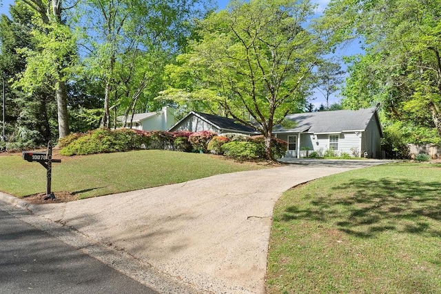 view of front of property with driveway and a front lawn