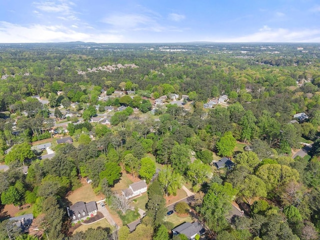 aerial view of property and surrounding area with a forest