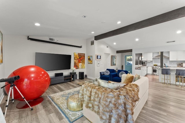 living area featuring light wood-type flooring, baseboards, and recessed lighting