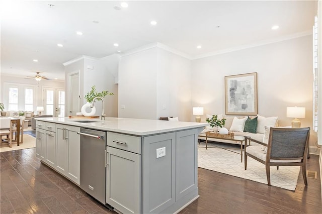 kitchen featuring a sink, open floor plan, dishwasher, gray cabinets, and dark wood-style flooring