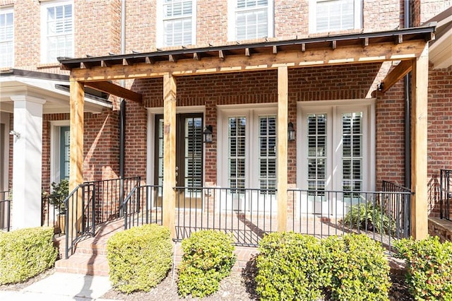 view of exterior entry with brick siding