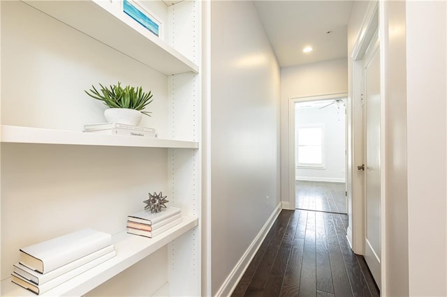 hall with recessed lighting, baseboards, and dark wood-style flooring