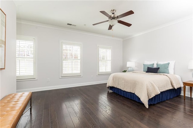 bedroom featuring visible vents, multiple windows, dark wood-type flooring, and crown molding