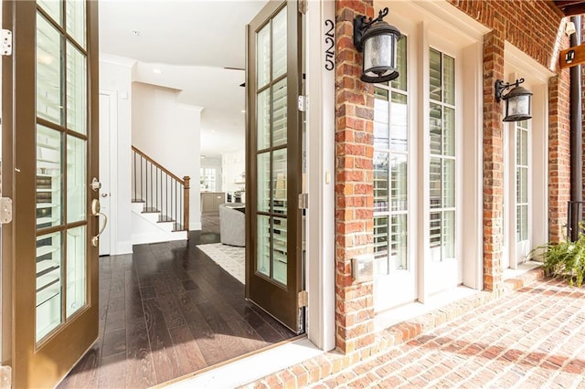 exterior space with a porch and brick siding