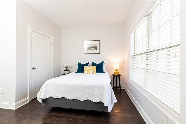 bedroom featuring baseboards and wood finished floors