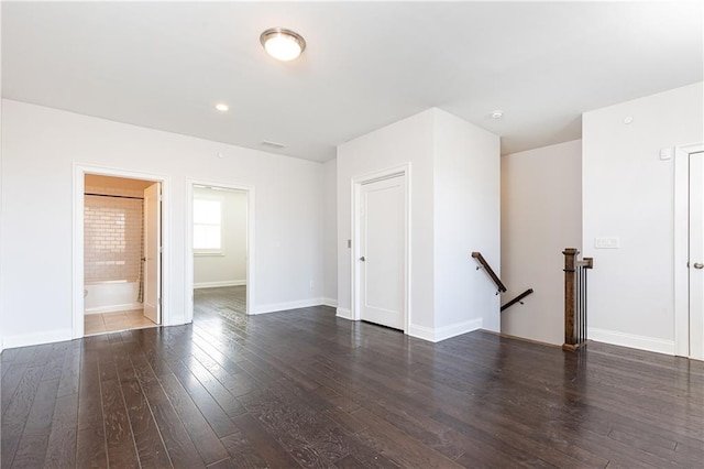 empty room with hardwood / wood-style floors and baseboards