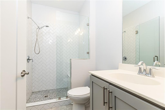 full bath featuring vanity, toilet, and a stall shower