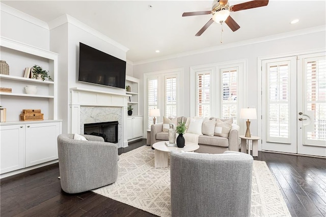 living area featuring recessed lighting, a fireplace, dark wood-style flooring, and ornamental molding