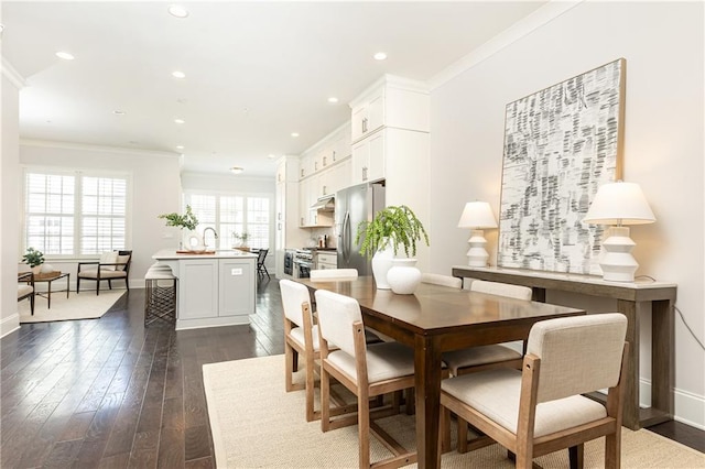 dining room featuring recessed lighting, dark wood-type flooring, baseboards, and ornamental molding