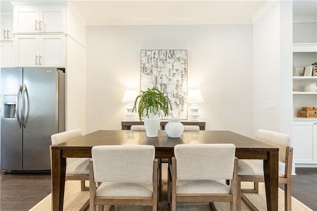 dining space with dark wood finished floors and ornamental molding