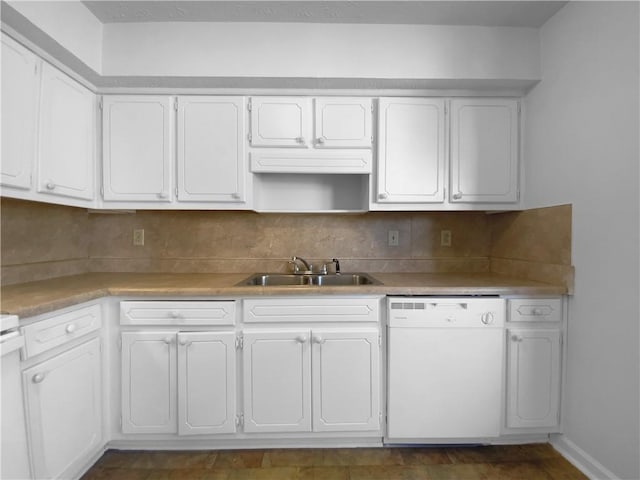 kitchen featuring white cabinets, white dishwasher, and a sink