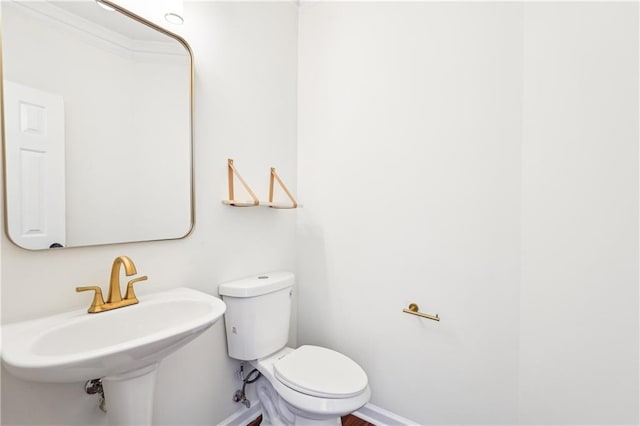 half bathroom with toilet and a sink