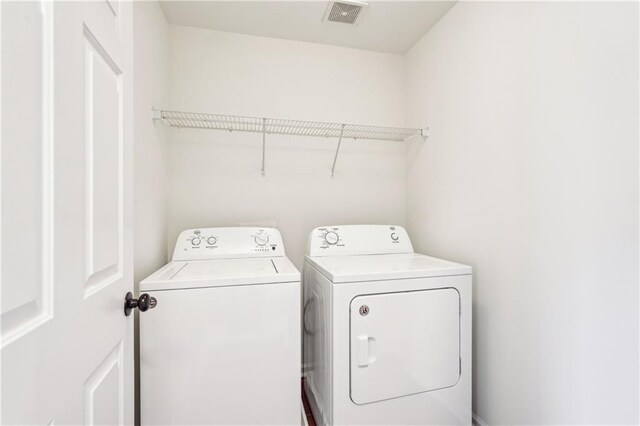 full bathroom featuring a stall shower, visible vents, a sink, and wood finished floors