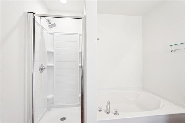 walk in closet with attic access and light carpet