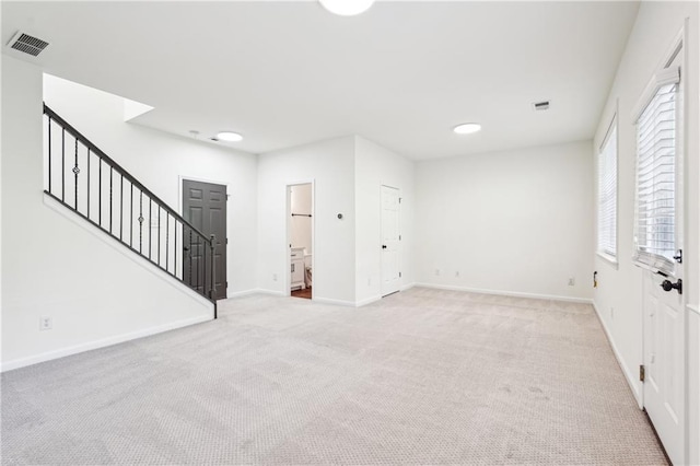 interior space with carpet, stairs, and visible vents