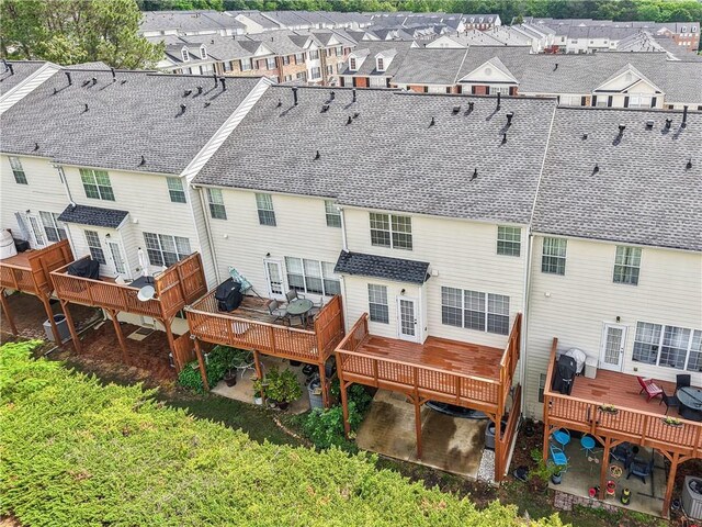 birds eye view of property featuring a view of trees
