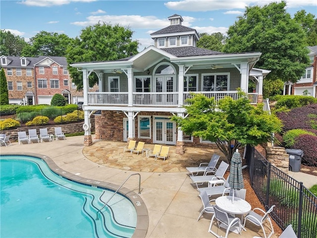 back of property featuring a patio, ceiling fan, fence, and french doors