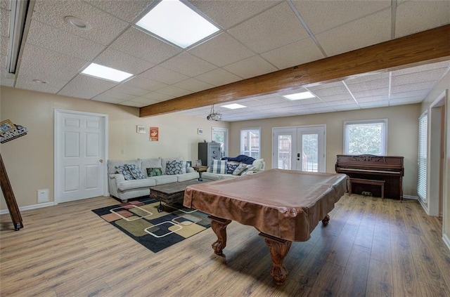 recreation room with a paneled ceiling, hardwood / wood-style floors, pool table, and french doors