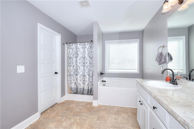 bathroom featuring vanity and independent shower and bath