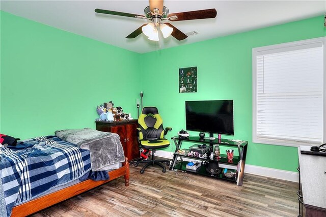 bedroom with hardwood / wood-style floors and ceiling fan