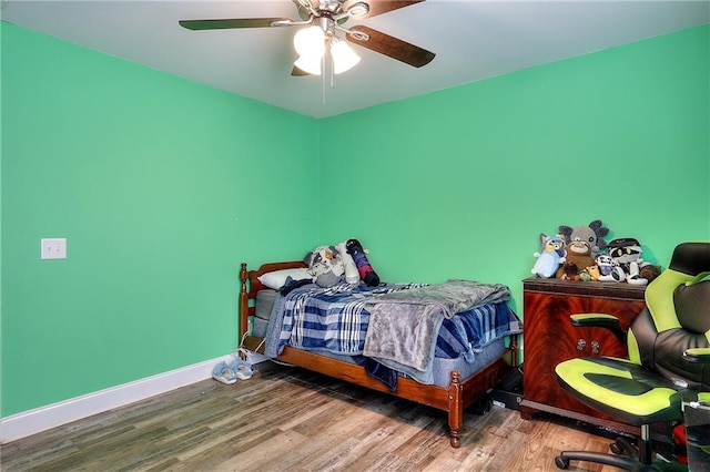 bedroom featuring hardwood / wood-style floors and ceiling fan