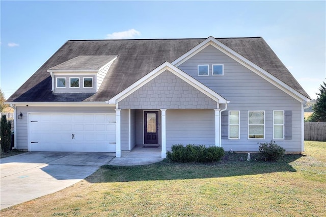 view of front of property with a front lawn and a garage