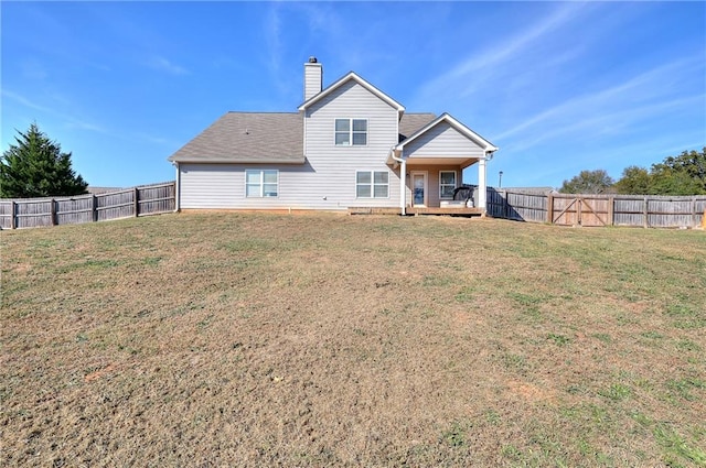 back of property featuring a deck and a lawn