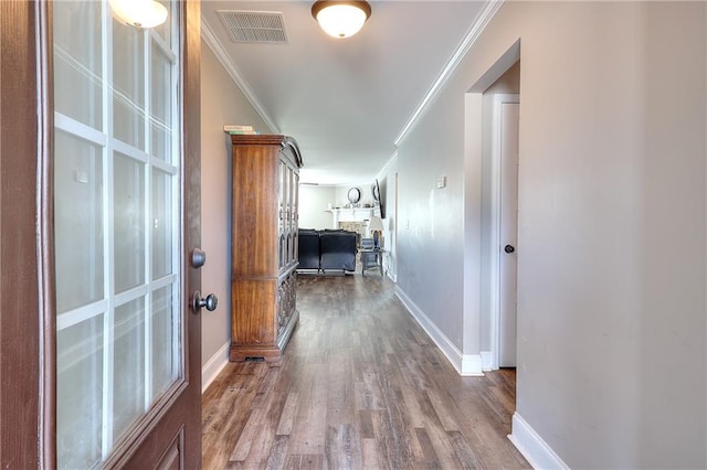 corridor with crown molding and hardwood / wood-style floors