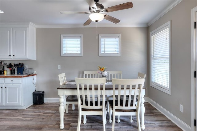 dining space featuring a healthy amount of sunlight, ornamental molding, and hardwood / wood-style floors