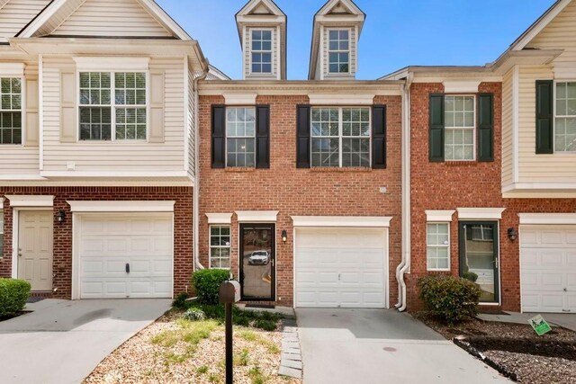 786 Brookside Parc Ln, Avondale Estates, GA 30002 - townhome / multi-family property with concrete driveway, brick siding, and an attached garage