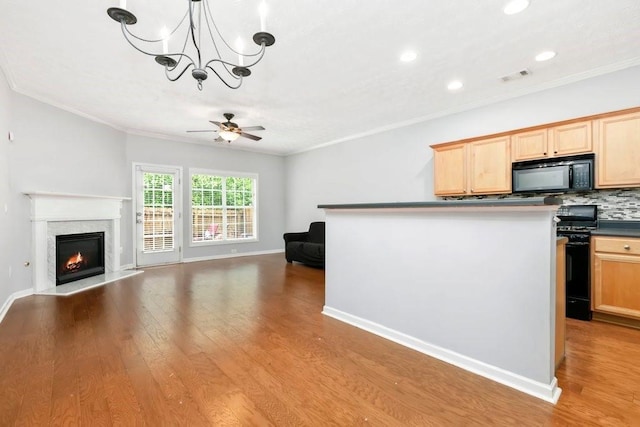 786 Brookside Parc Ln, Avondale Estates, GA 30002 - kitchen featuring black appliances, ornamental molding, ceiling fan, open floor plan, and wood finished floors