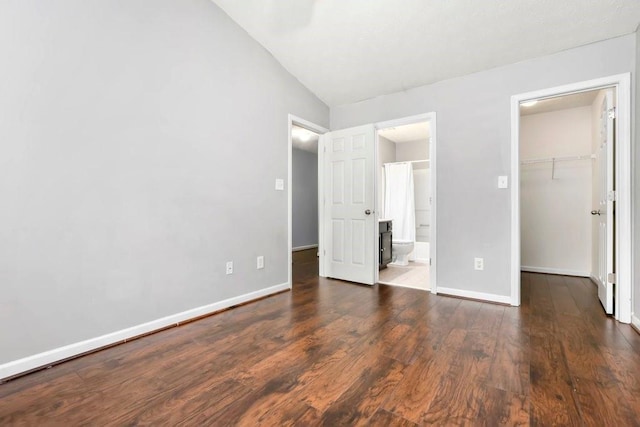 786 Brookside Parc Ln, Avondale Estates, GA 30002 - unfurnished bedroom with a walk in closet, wood finished floors, a closet, ensuite bathroom, and lofted ceiling