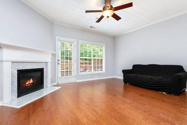 786 Brookside Parc Ln, Avondale Estates, GA 30002 - living area featuring wood finished floors, a premium fireplace, a ceiling fan, and crown molding