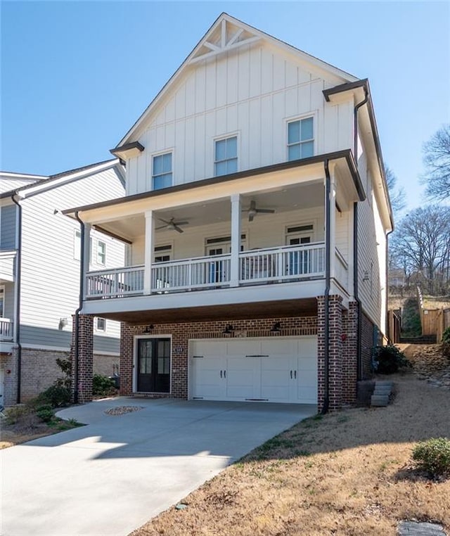 view of front of home with concrete driveway, brick siding, and board and batten siding