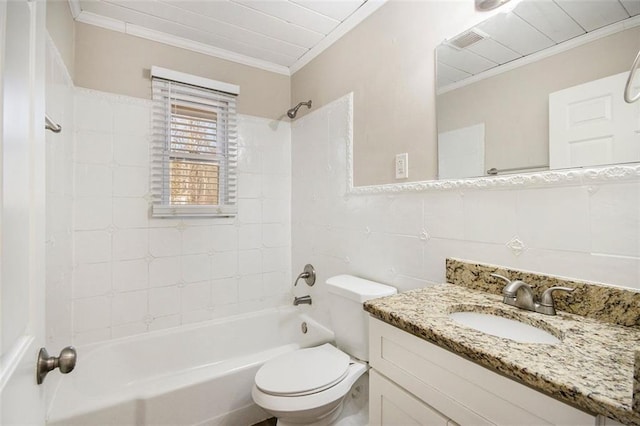 full bathroom with tiled shower / bath combo, vanity, tasteful backsplash, tile walls, and toilet