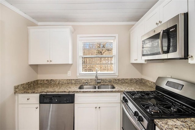 kitchen with sink, light stone countertops, appliances with stainless steel finishes, ornamental molding, and white cabinets