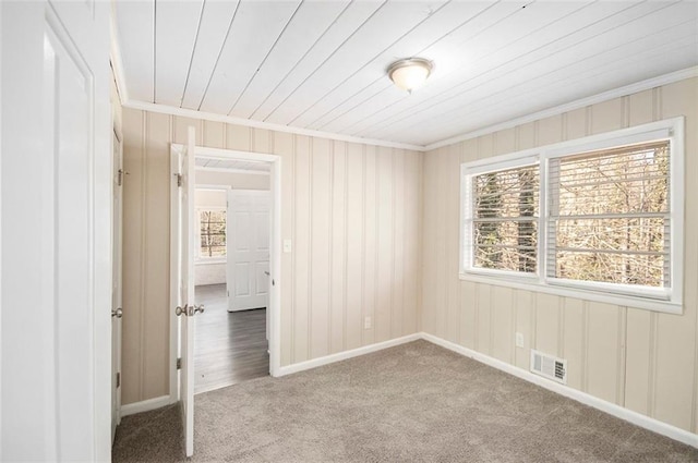 carpeted spare room featuring ornamental molding