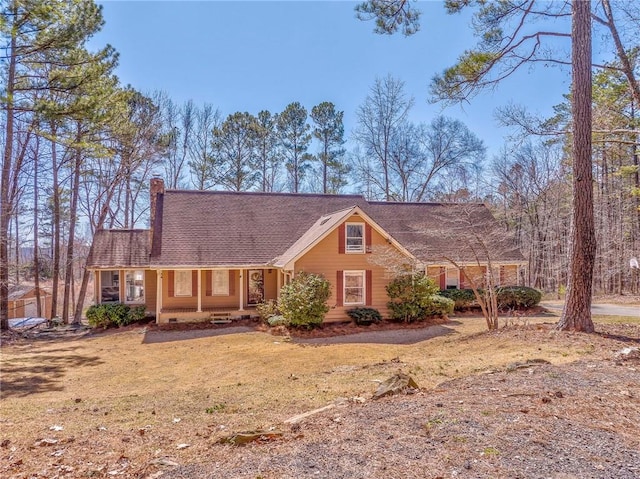 view of front of home with a chimney and a front yard