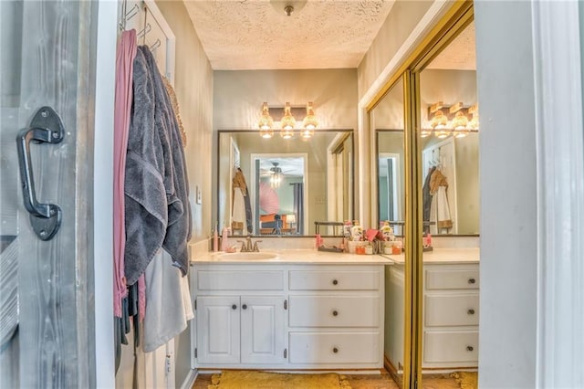 bathroom with vanity and a textured ceiling