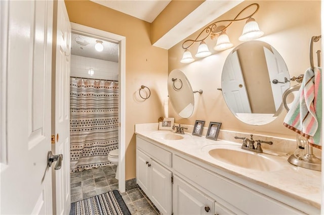 bathroom with a sink, curtained shower, toilet, and double vanity