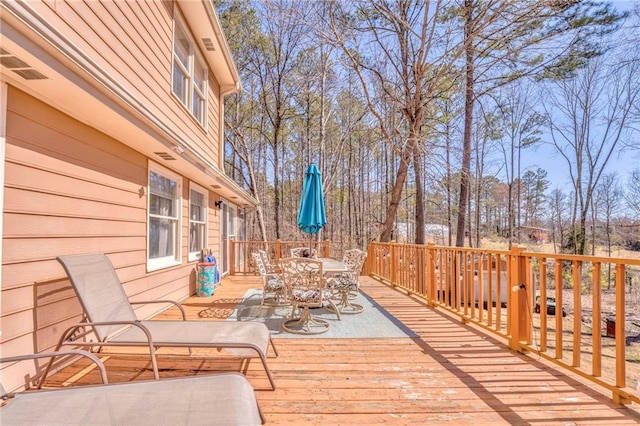 wooden terrace featuring outdoor dining area