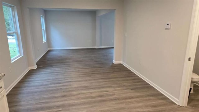 hallway with dark hardwood / wood-style flooring