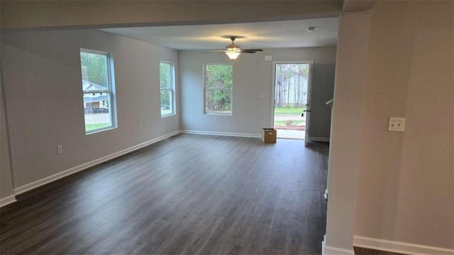 empty room with dark hardwood / wood-style flooring and ceiling fan